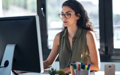 Woman working on computer seated at desk