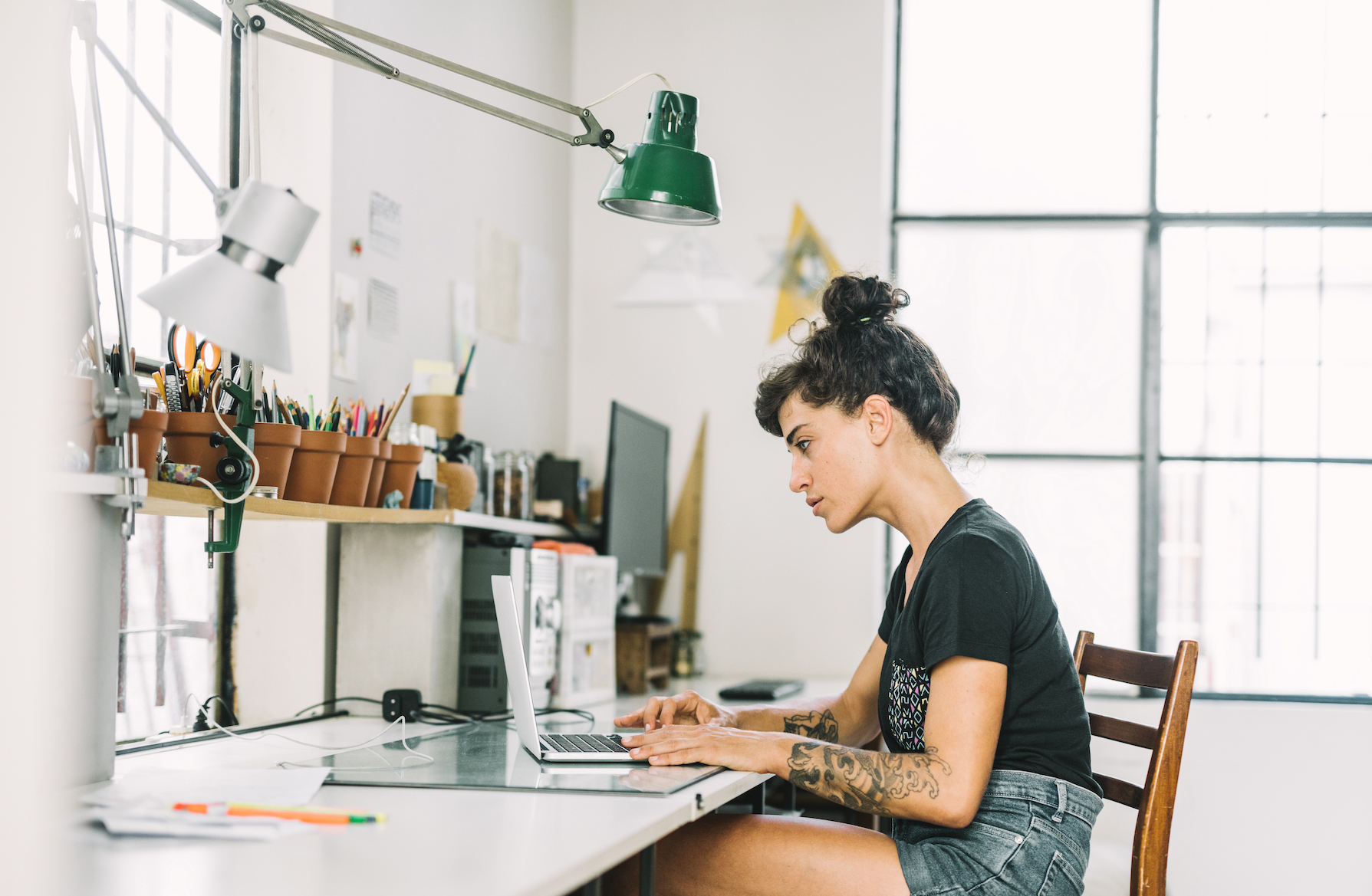 Artist freelancer at desk with laptop