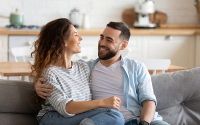 Young couple laughing on the couch