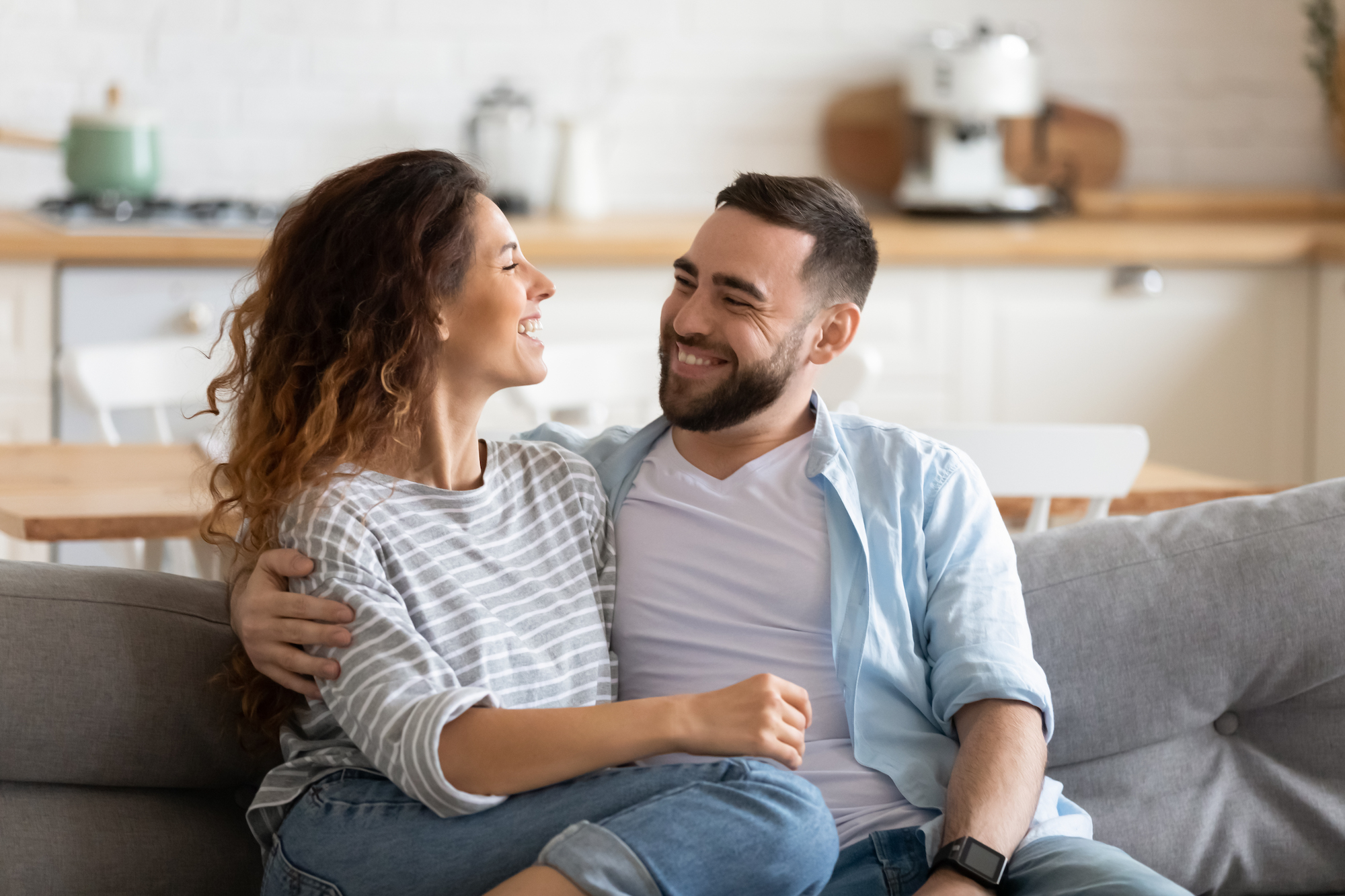 Young couple laughing on the couch