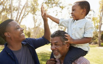 Grandfather With Son And Grandson Having Fun In Park