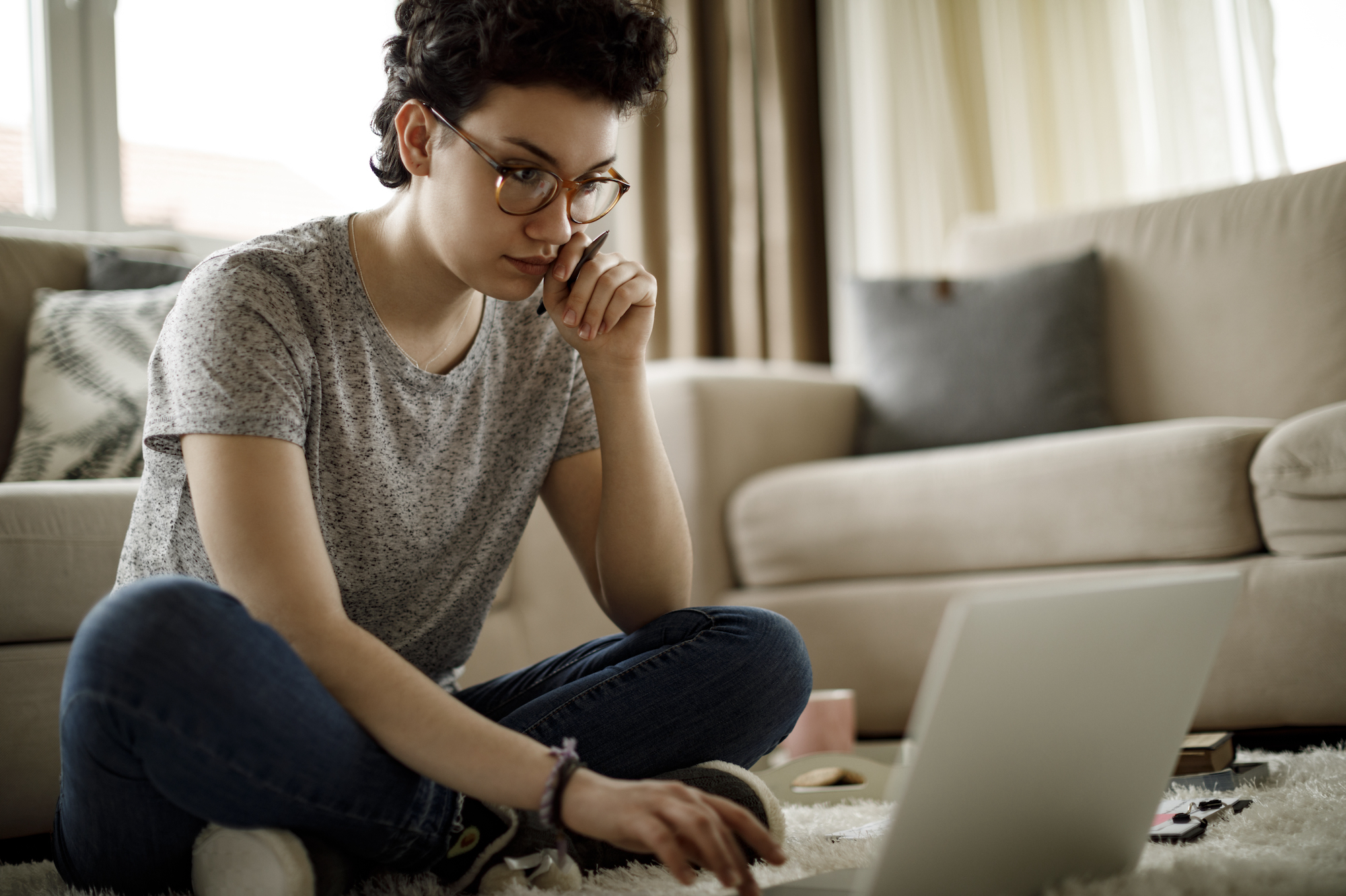 Young woman in living room on laptop